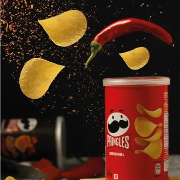 Pringles can with chips and a chilli in the air