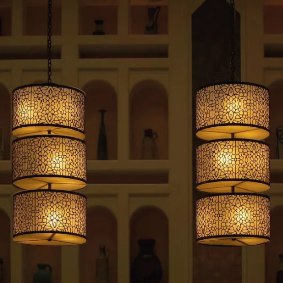 Carved lanterns glowing in front of wall niches