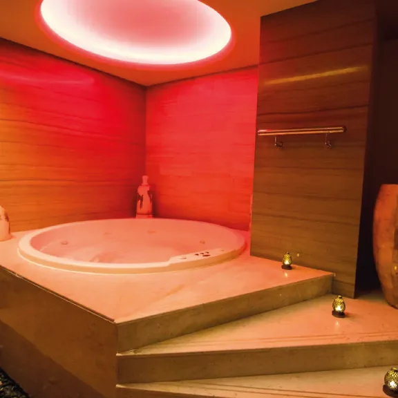 Hotel spa jacuzzi lit in red and orange