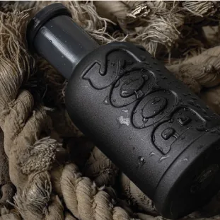 Black embossed bottle resting on rope