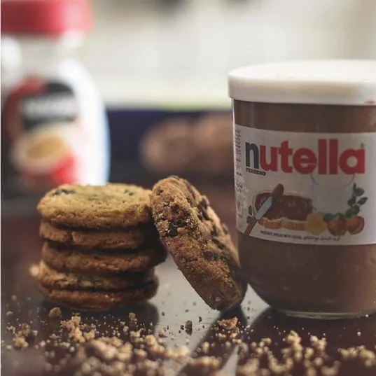 Nutella jar beside a stack of cookies